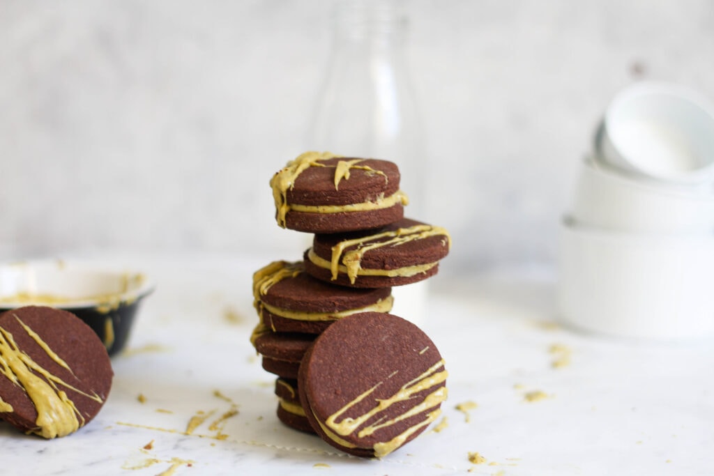 Chocolate cookies with pistachio ganache filling and milk bottle