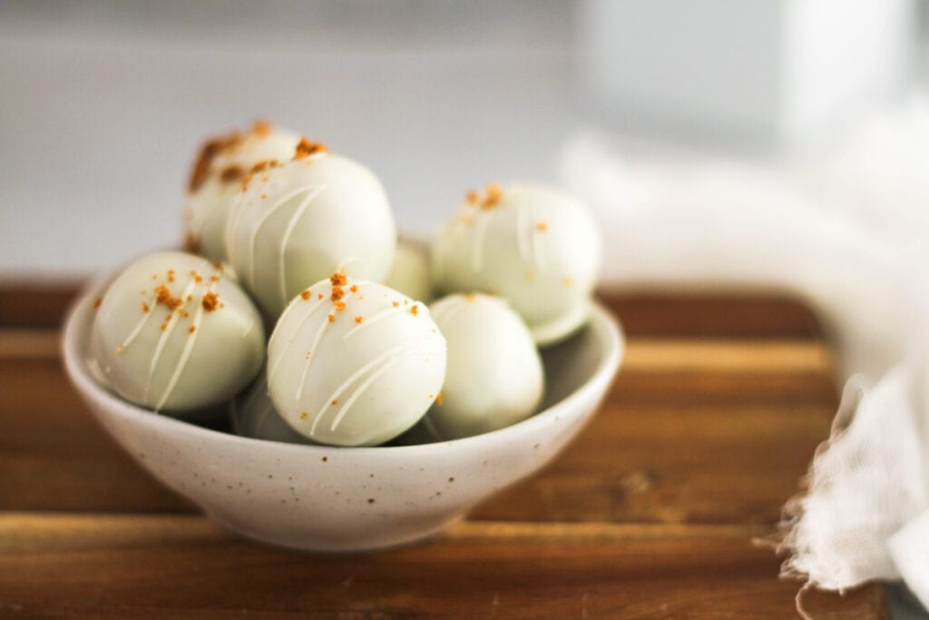 white chocolate biscoff truffles on wood board