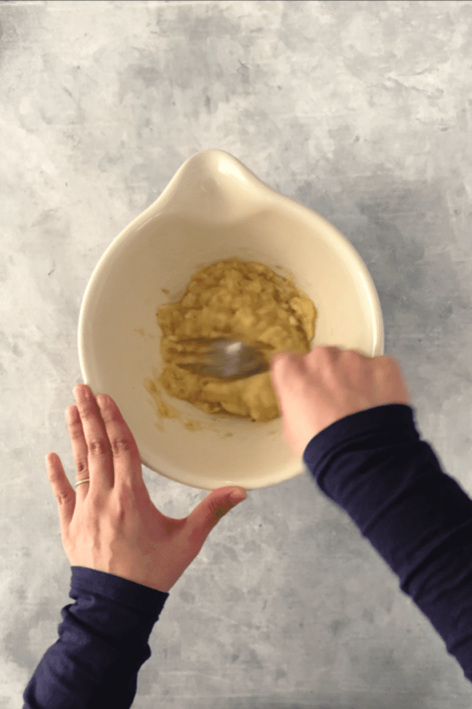 Mashing bananas with a fork in a bowl