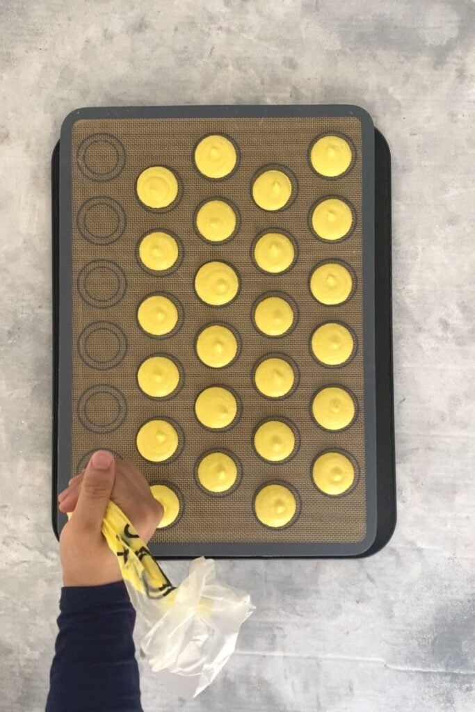 Piping yellow macarons