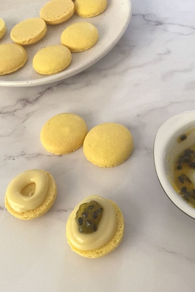 Filling macarons with passionfruit centre