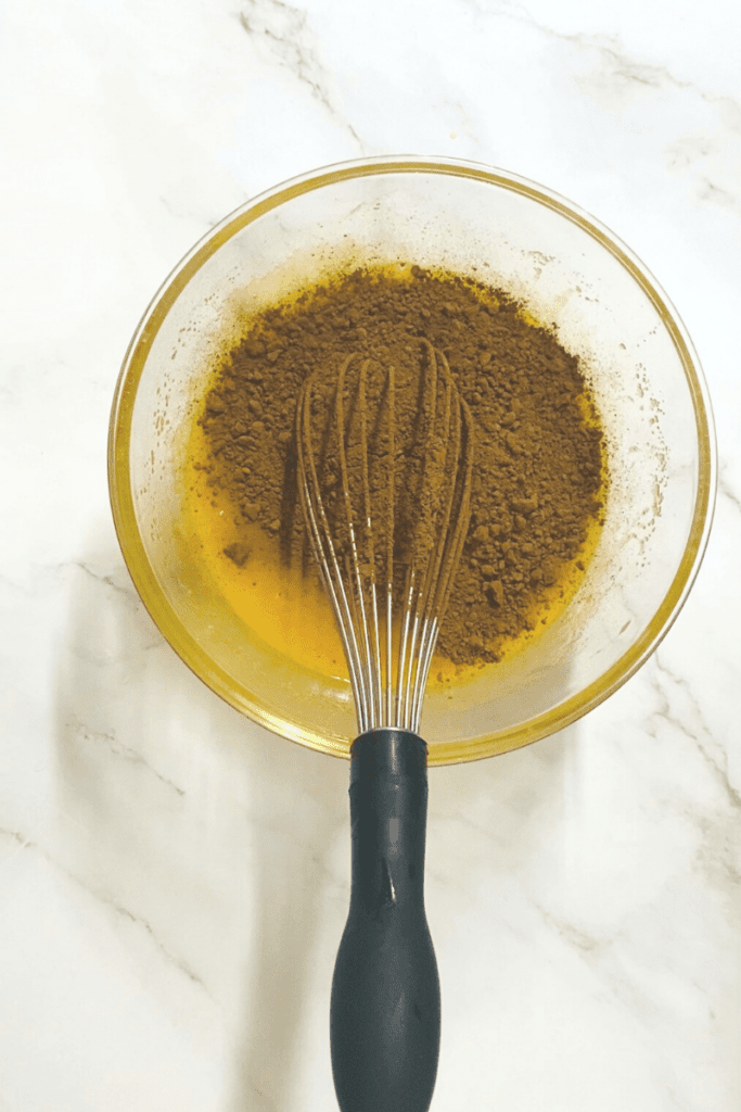 Cocoa powder added into melted butter mixture