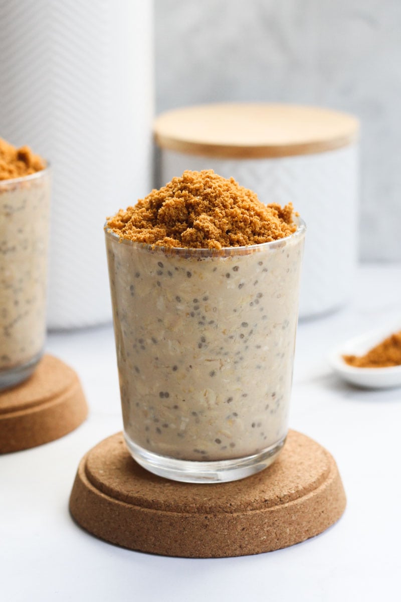 glass of biscoff overnight oats topped with crushed biscoff