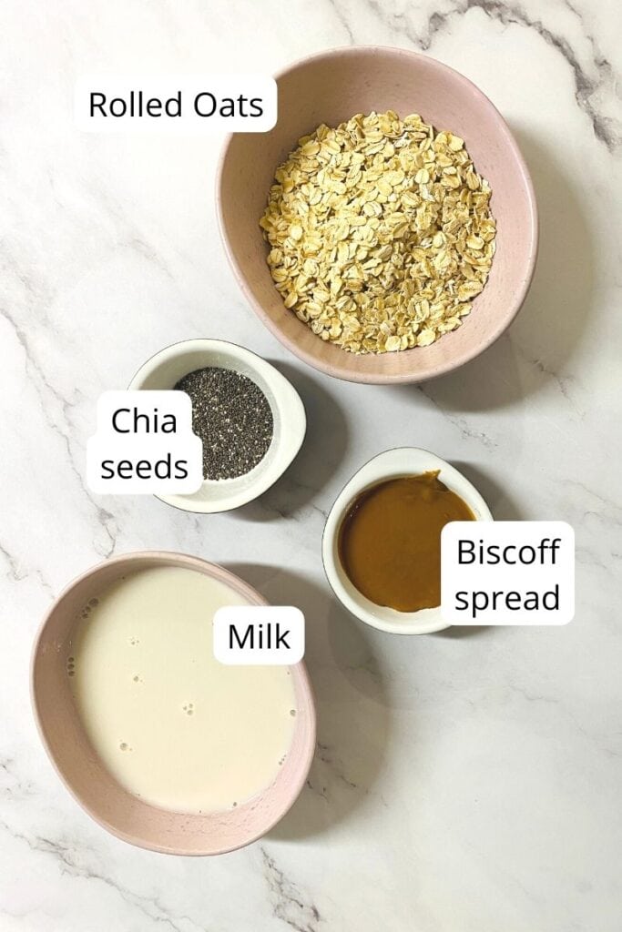 ingredients for overnight oats in bowls with biscoff spread.