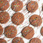 Chocolate cookies with chocolate drizzle and sprinkles