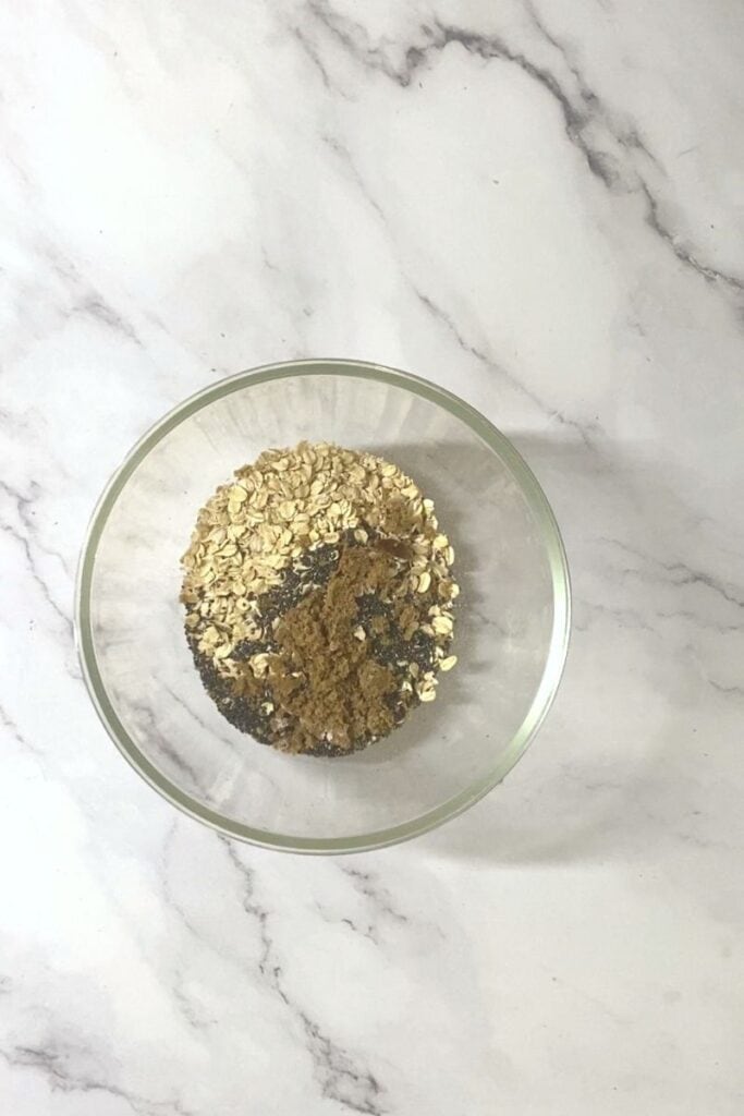 Oats, chia seeds, sugar in a bowl.