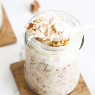 A spoon of carrot cake oats being lifted out of jar.