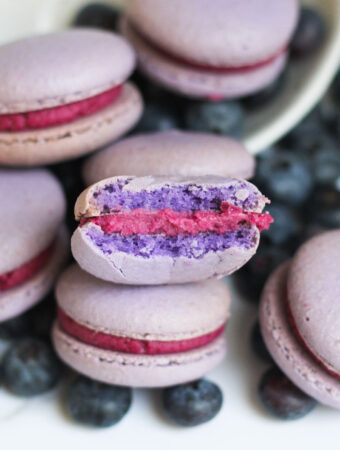 Blueberry Macarons with a bite taken out of the one in front.