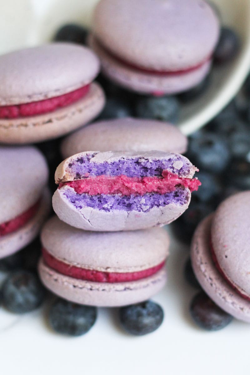 Blueberry Macarons with a bite taken out of the one in front.