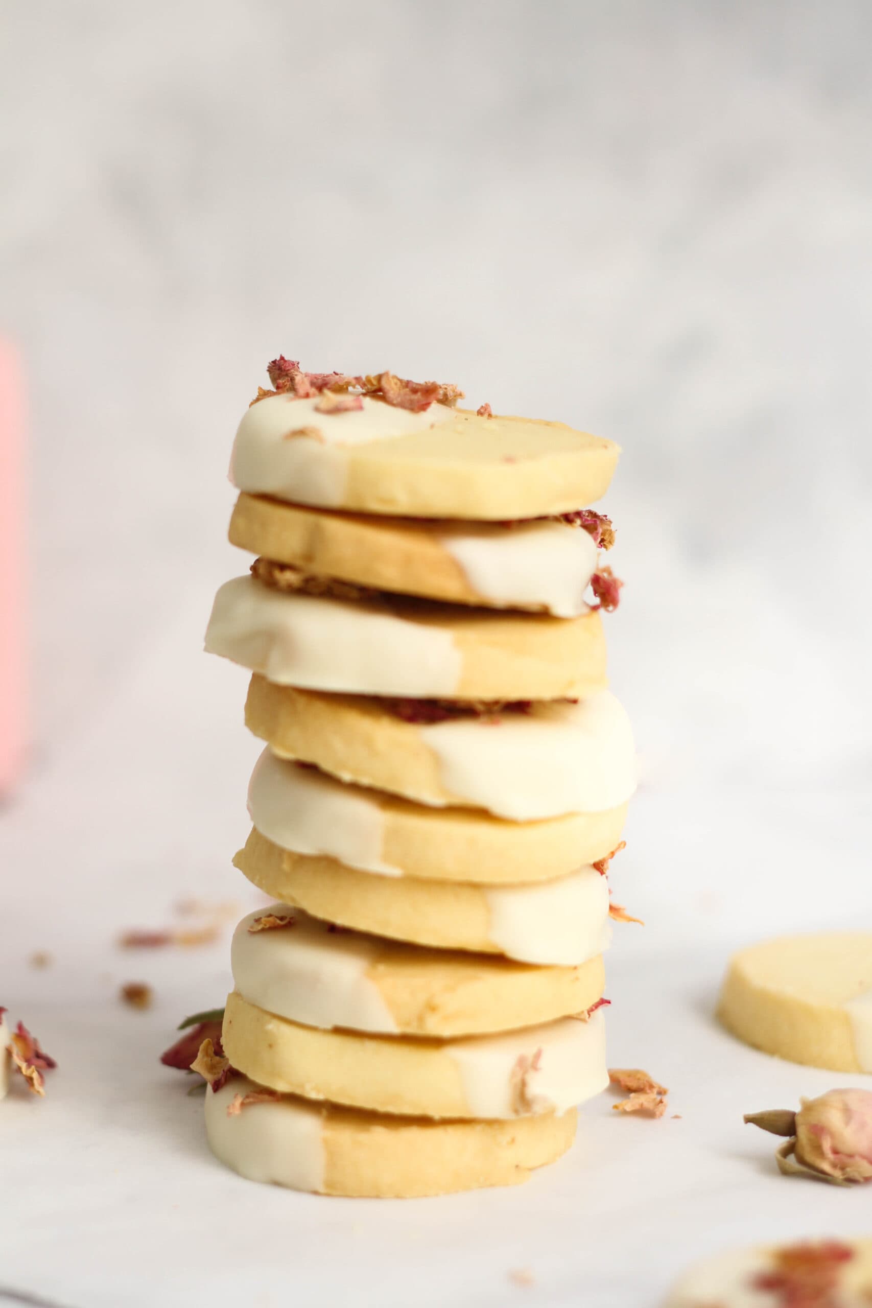 Stack of shortbread cookies, with rose petals in the background.