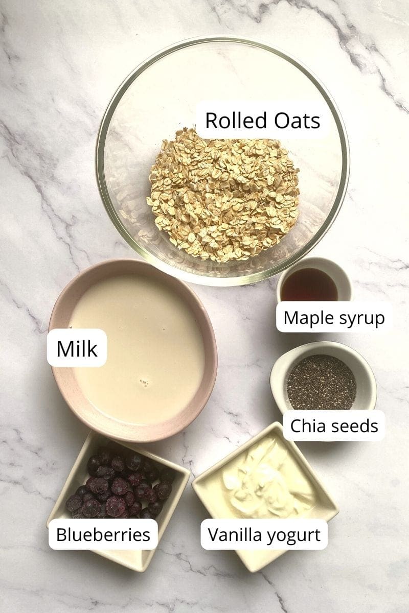 Ingredients in bowls for blueberry cheesecake overnight oats.
