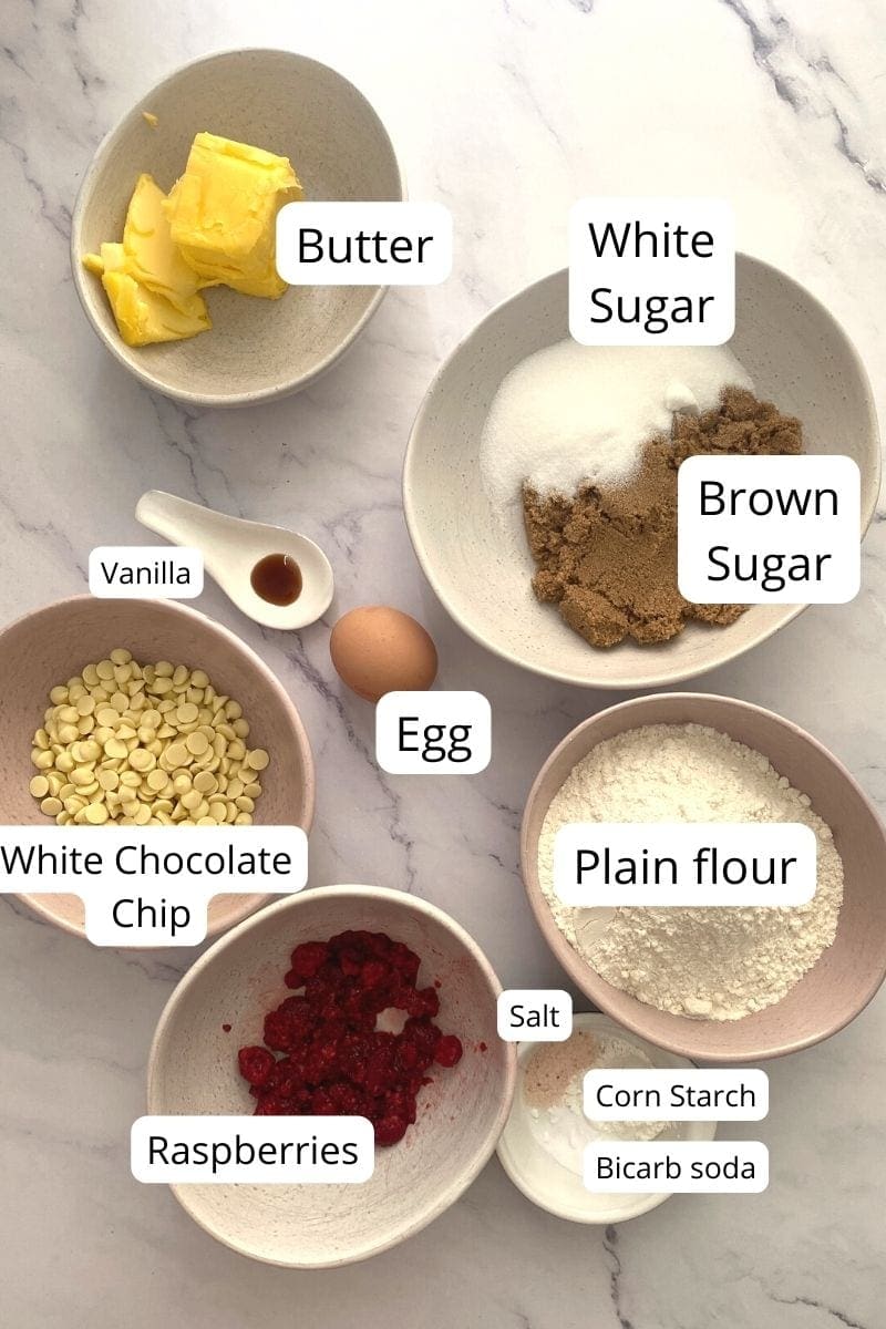 Ingredients in bowls of white chocolate chip raspberry cookies