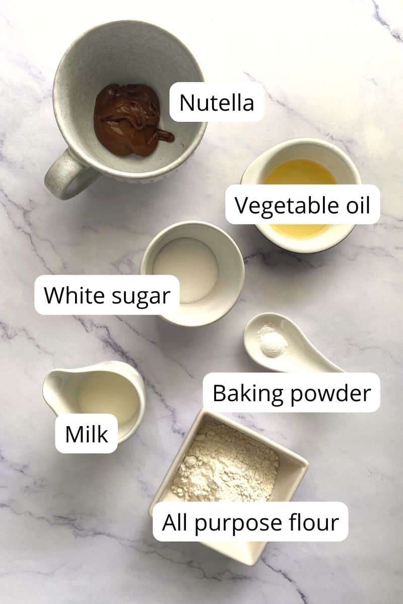 Ingredients of nutella mug cake in bowls.