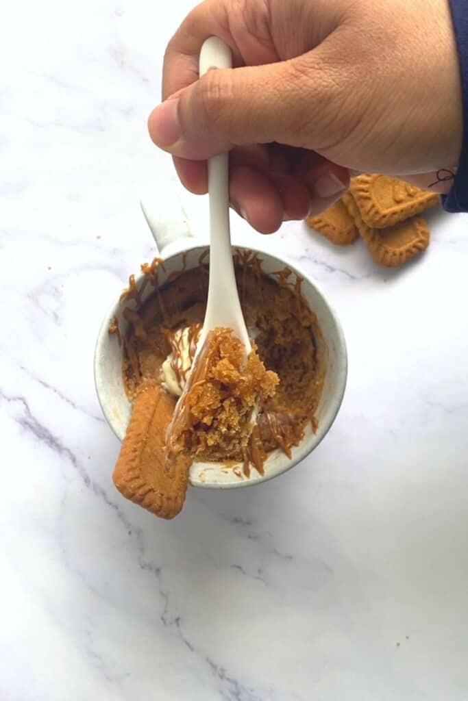 Spoon out of biscoff mug cake.