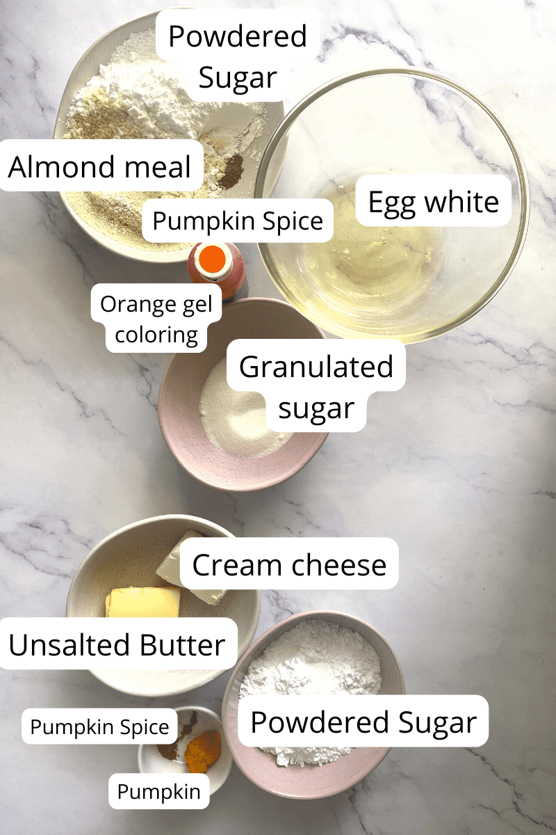 Ingredients of pumpkin spice macarons in bowls.