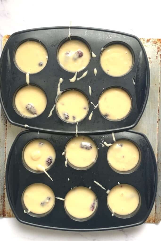 Mulberry muffin batter poured into muffin pan.