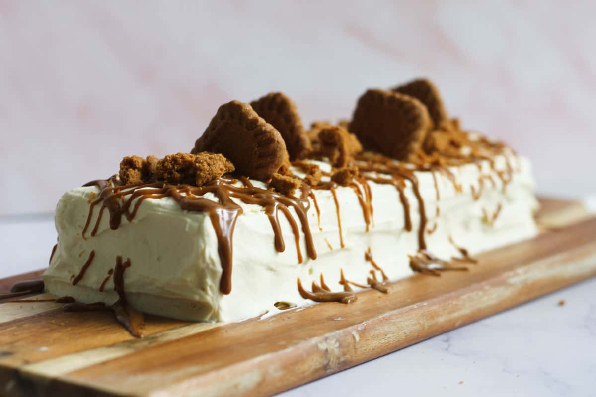 Biscoff ripple cake on wooden board.