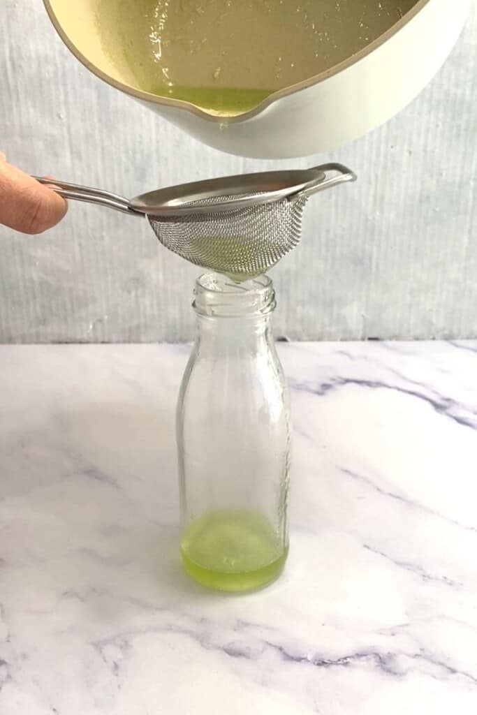 Pouring honeydew syrup into jug.