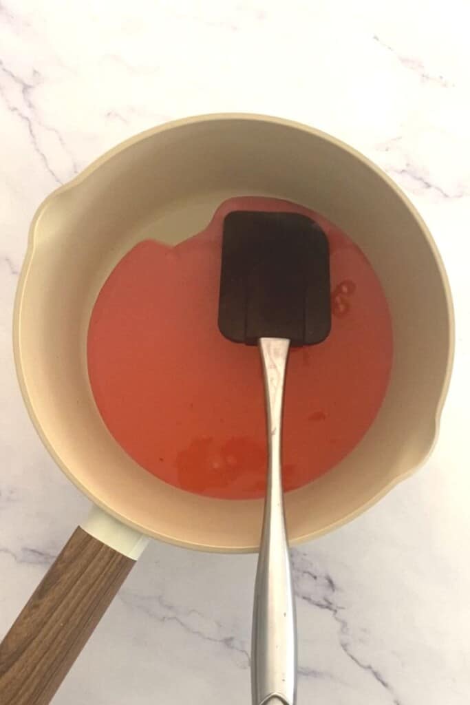Rose syrup in pan.