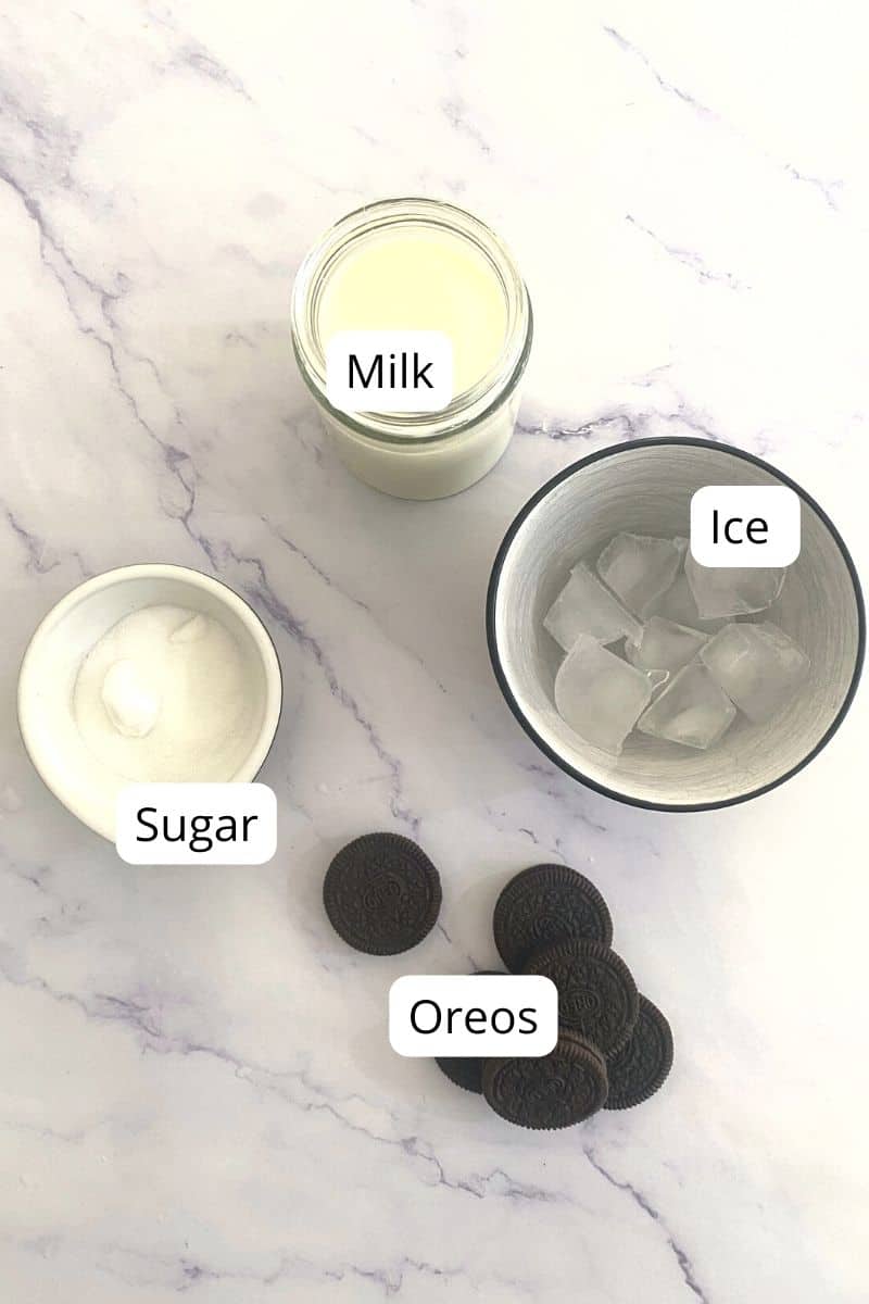 Ingredients of Oreo Milkshake in bowls without ice cream.