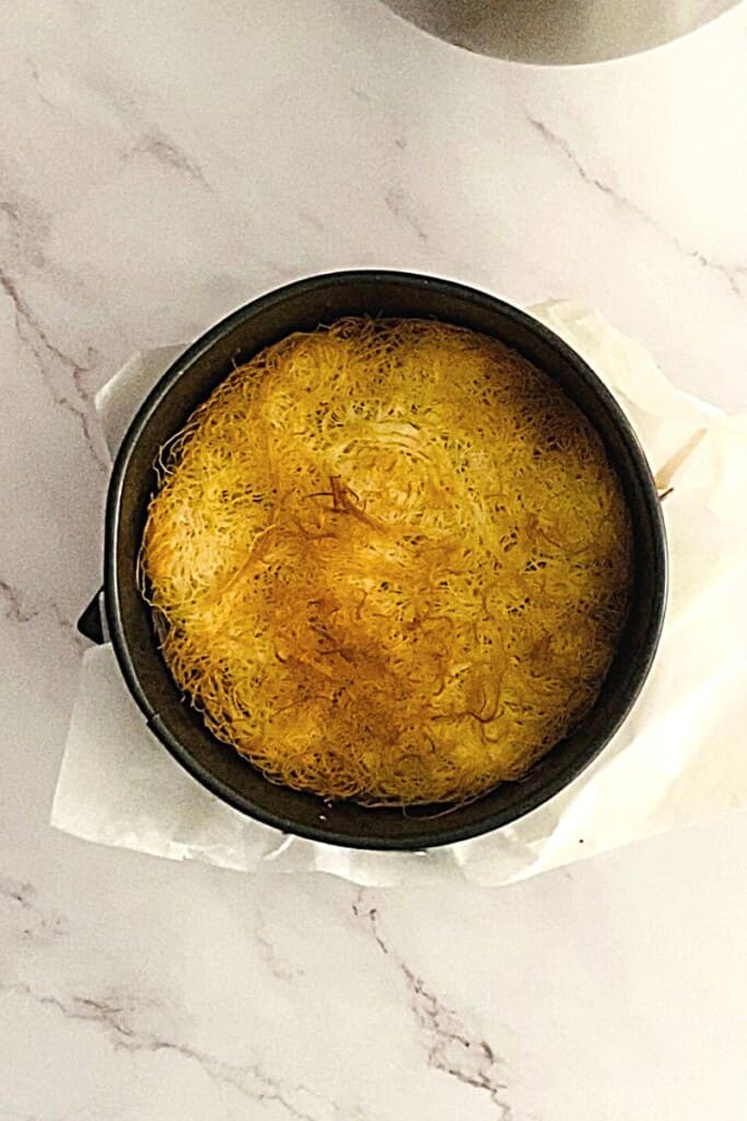 Kataifi crust baked till golden in springform pan.