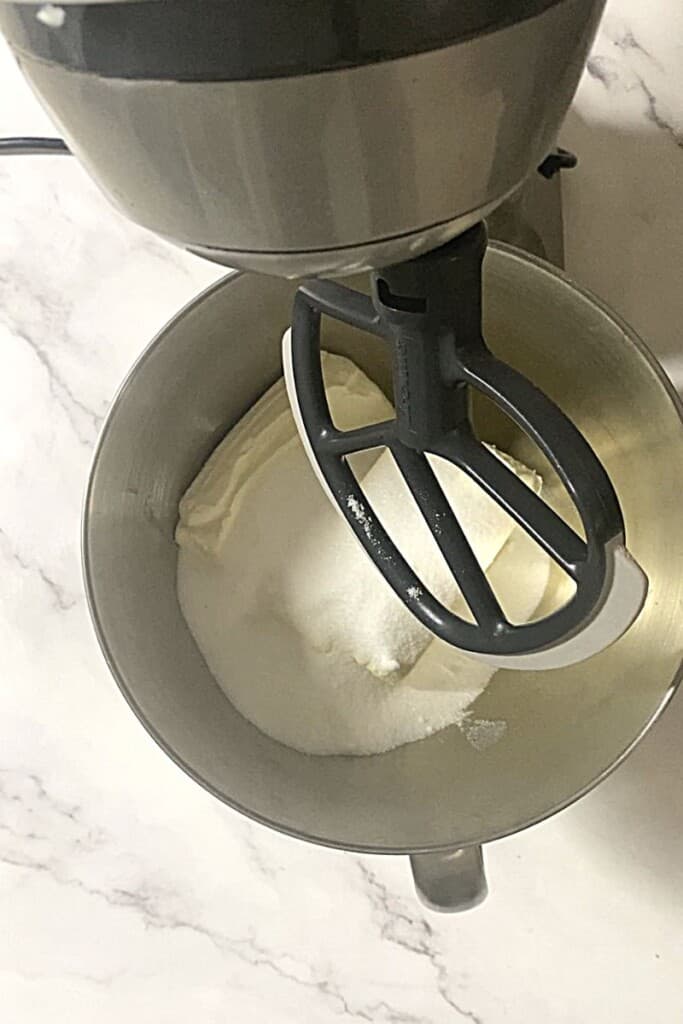 Cream cheese and sugar in mixer.