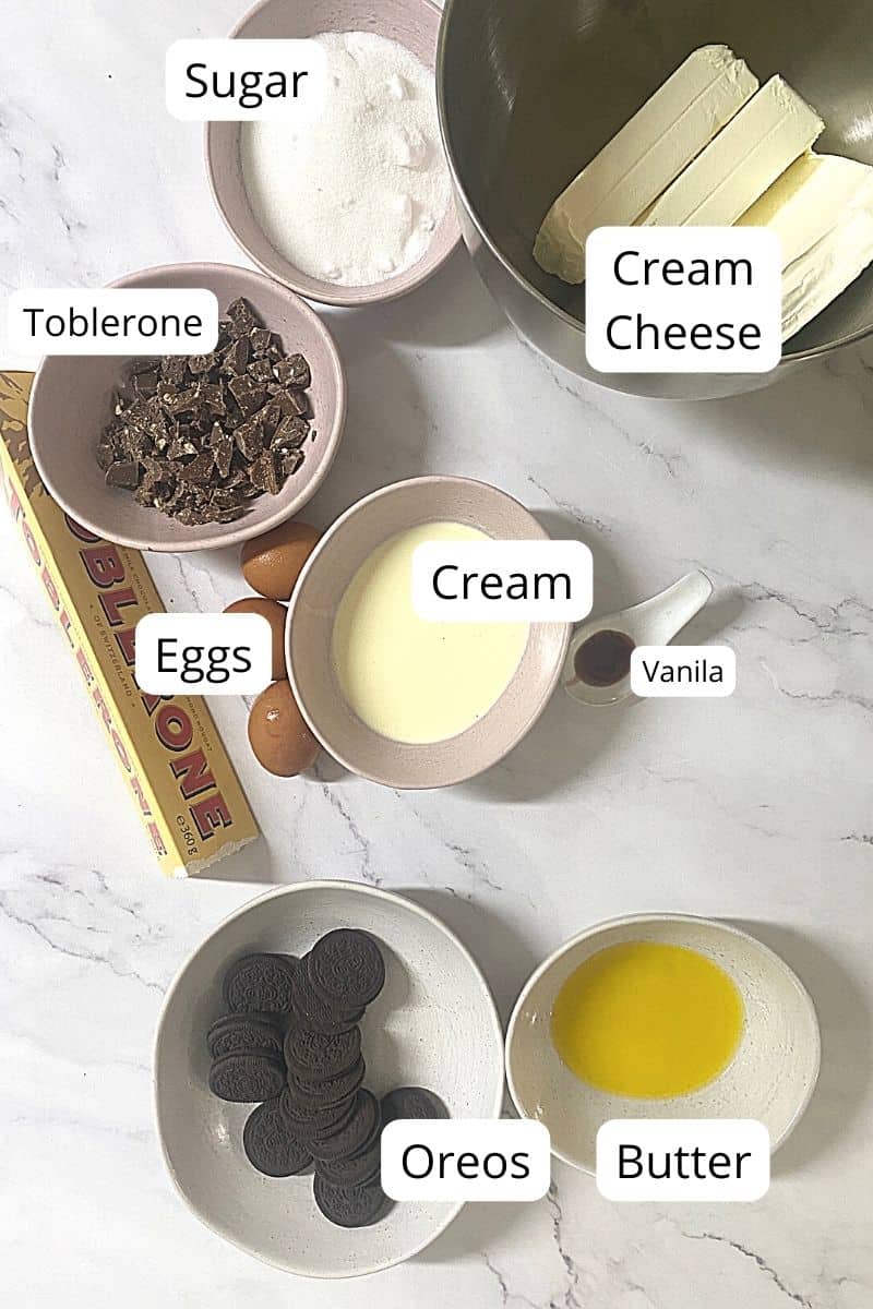 Ingredients for Toblerone Cheesecake laid out in bowls.