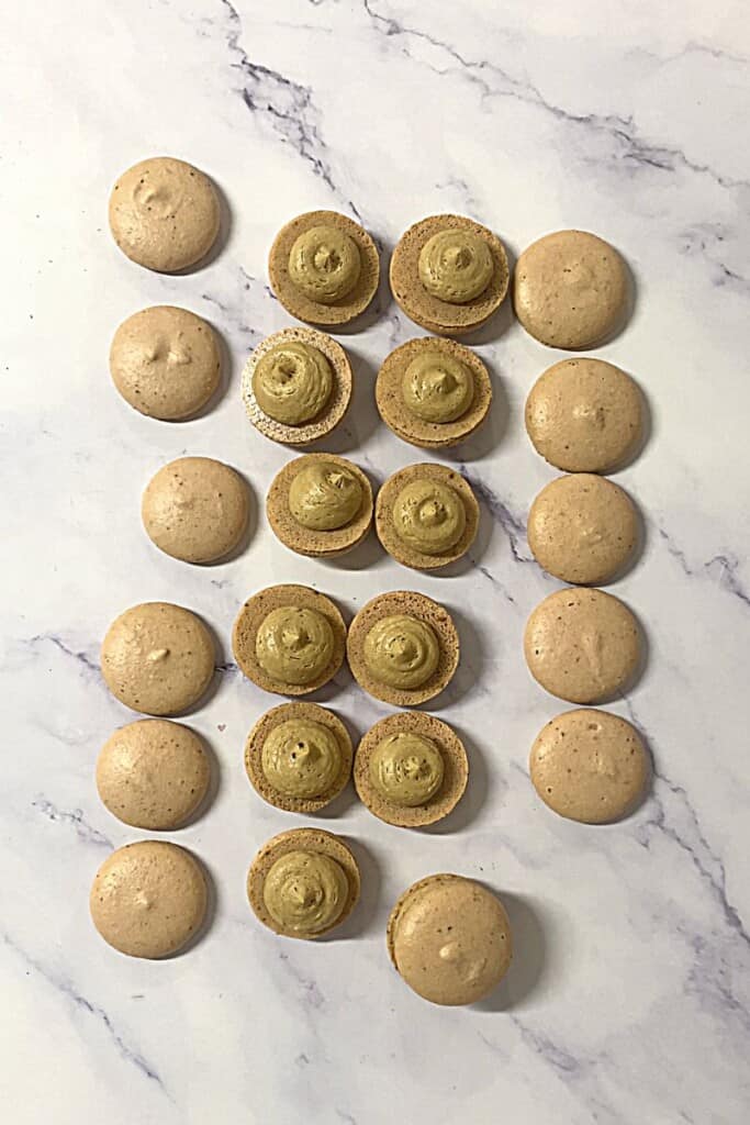Coffee macarons filled with coffee buttercream.